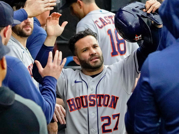 Houston Astros second baseman Jose Altuve (27) is congratulated in the dugout after scoring against the Chicago White Sox on a one-run RBI single hit by left fielder Michael Brantle